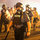 August 17, 2014: Cops surrounded by tear gas during the Ferguson protests